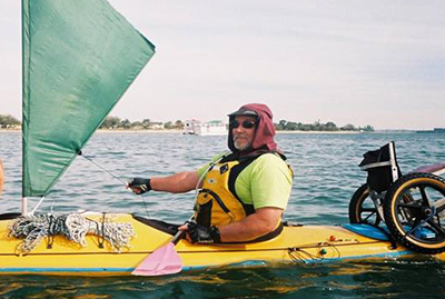 David Kayaking with his home made kayak chair strapped on the back